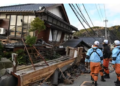 Firefighters inspect collapsed wooden houses in Wajima, Ishikawa prefecture on January 2, 2024.(AFP)