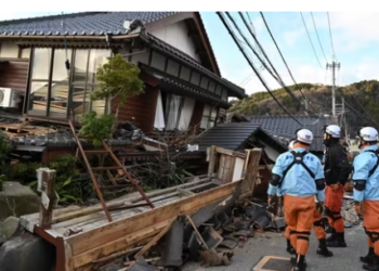 Firefighters inspect collapsed wooden houses in Wajima, Ishikawa prefecture on January 2, 2024.(AFP)