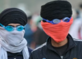 Farmers wear protective goggles to safeguard from teargas fired by security personnel during a protest to demand minimum crop prices.
