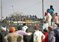 Protesting farmers stand facing the police barricade near Shambhu border on Friday. (AP)
