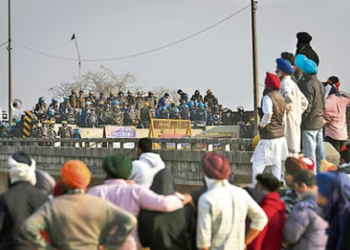Protesting farmers stand facing the police barricade near Shambhu border on Friday. (AP)