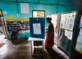 A woman casts vote during the first round of polling of India's national election in Bahona village, Jorhat, Assam