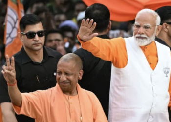 Prime Minister Narendra Modi and UP CM Yogi Adityanath during a roadshow in Varanasi on May 13, 2024.
