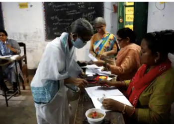 A woman gets her name checked in a voters' list