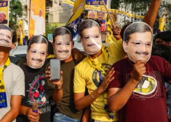 Supporters wear facemasks of jailed Delhi chief minister Arvind Kejriwal, in New Delhi, on April 28. (PTI)