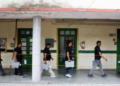 Election officials carry EVMs at a counting centre in Delhi on Tuesday. (REUTERS)