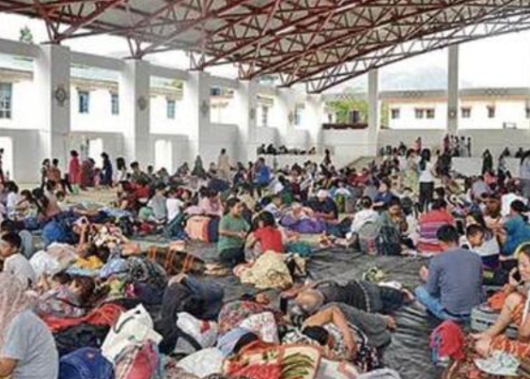People evacuated from violence-affected areas take rest at a shelter (ANI Photo)