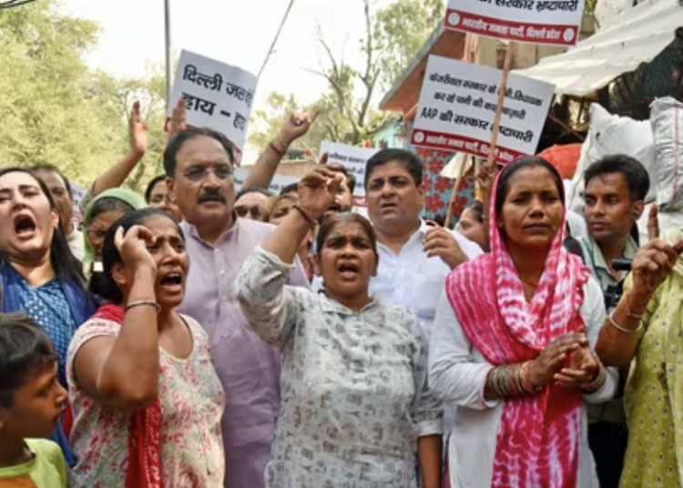 Bharatiya Janata Party (BJP) chief Virendra Sachdeva, party MP Bansuri Swaraj and others raise slogans as they stage a protest against the Aam Aadmi Party (AAP)-led Delhi government over the ongoing water shortage the national capital on June 19.(ANI)