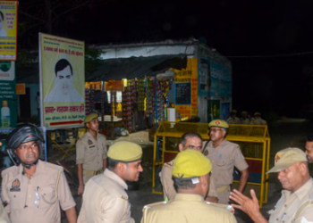 Police personnel stand guard at Ram Kutir Charitable Trust, the ashram of preacher Baba Narayan Hari.