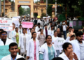 Resident doctors of BHU take part in a march demanding justice for RG Kar Medical College rape and murder victim in Varanasi on Friday.(PTI)