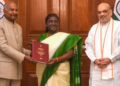 President Droupadi Murmu being presented a report on simultaneous elections in the country by former president Ram Nath Kovind