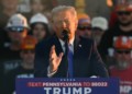 Former US President and Republican presidential candidate Donald Trump speaks behind bulletproof glass during a campaign rally at Arnold Palmer Regional Airport in Latrobe, Pennsylvania, October 19, 2024. (Photo by Jim WATSON / AFP)(AFP)