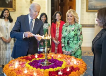 US President Joe Biden lights a lamp as First lady Jill Biden and Vice-President Kamala Harris look on during an event to celebrate Diwali, at the White House in Washington. (PTI)