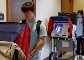 Students cast their ballots as they take advantage of early voting in the 2024 election at a the University of Wisconsin.(AFP)