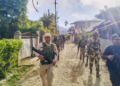 Security personnel conduct patrolling in a sensitive area of Manipur on Wednesday. (PTI)